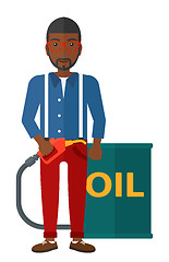 Image showing Man with oil can and filling nozzle.