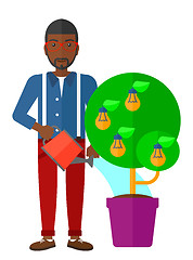 Image showing Man watering tree with light bulbs.