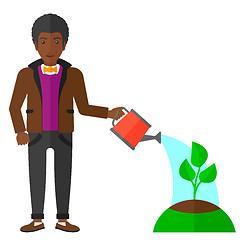 Image showing Man watering tree.