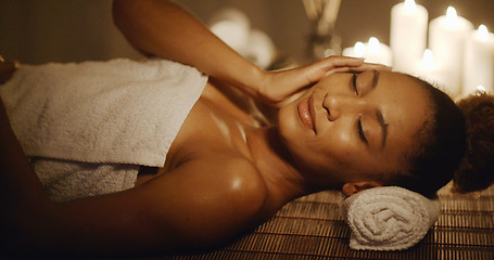 Image showing Woman Lying On Massage Table And Touching Her Face