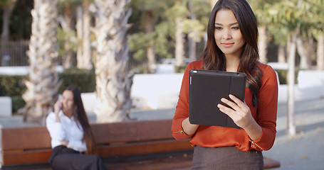 Image showing Young businesswoman using a tablet outdoors