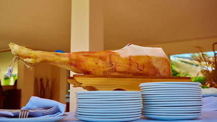 Image showing Slicing of italian dry-cured ham prosciutto.