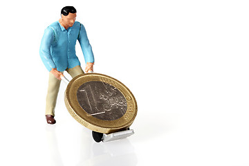 Image showing Miniature worker drives euro coins