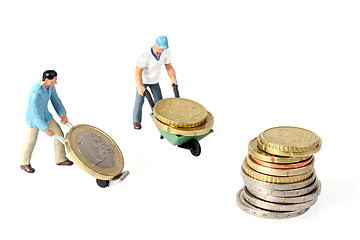 Image showing Two Miniature workers drives euro coins