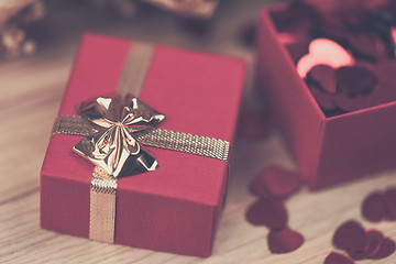 Image showing Red hearts confetti on wooden background