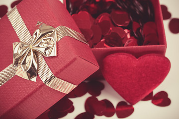 Image showing Red hearts confetti on wooden background