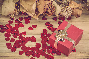 Image showing Red hearts confetti on wooden background