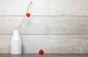 Image showing Orange dry flower in a white vase