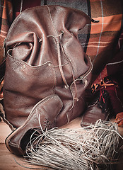 Image showing Leather products against the background of wool tartan