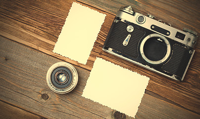 Image showing retro photo mock up, vintage camera and lens on old wooden backg