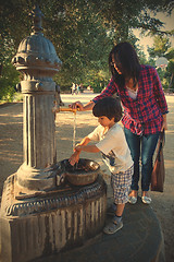 Image showing boy with his mother washing his hands under water stream from hy