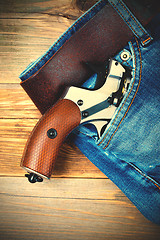 Image showing silver revolver nagant with brown handle in the pocket
