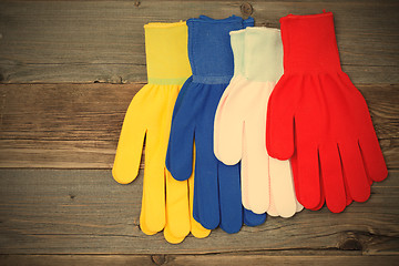 Image showing working gloves on old boards