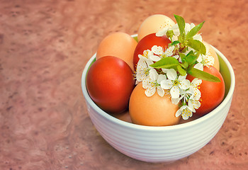 Image showing Easter eggs on the table in a ceramic vase.