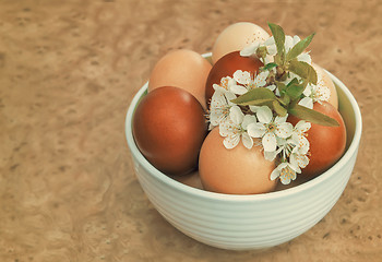 Image showing Easter eggs on the table in a ceramic vase.