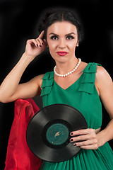 Image showing Pretty girl holding retro vinyl disc