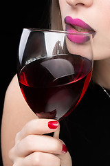 Image showing woman with glass red wine. saturated color, nails.