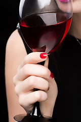 Image showing woman with glass red wine. saturated color, nails.