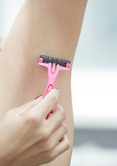 Image showing Woman shaving armpit