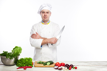 Image showing Chef posing with knife in his kitchen