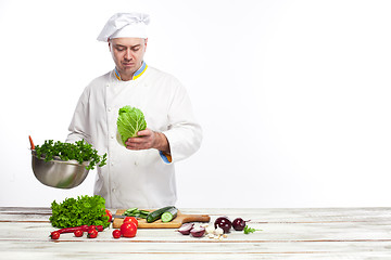 Image showing Chef cooking fresh vegetable salad in his kitchen