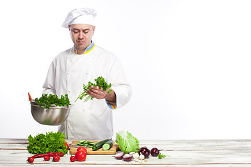 Image showing Chef cooking fresh vegetable salad in his kitchen