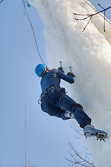 Image showing Man climbs upward on ice climbing competition