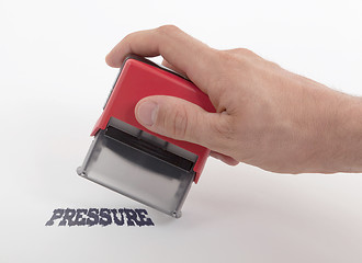 Image showing Plastic stamp in hand, Pressure