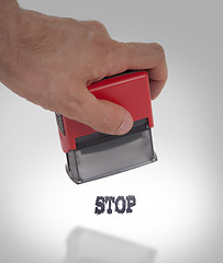 Image showing Plastic stamp in hand, isolated