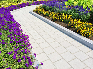 Image showing Tiled path in a blooming summer garden