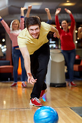 Image showing happy young man throwing ball in bowling club