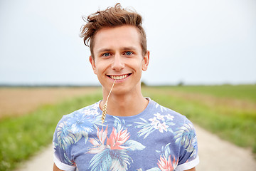 Image showing smiling young hippie man on country road