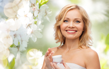 Image showing happy woman with cream jar