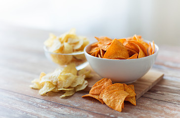 Image showing close up of potato crisps and nachos in glass bowl