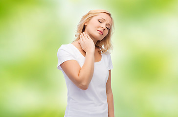 Image showing unhappy woman suffering from neck pain