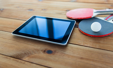 Image showing close up of table tennis rackets and tablet pc