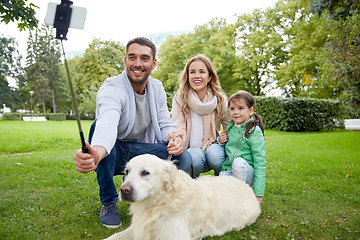 Image showing happy family with dog taking selfie by smartphone