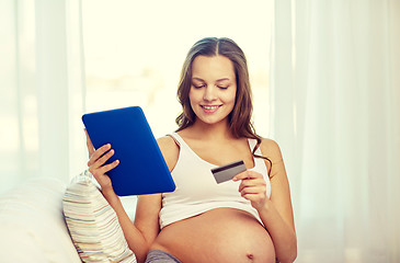 Image showing pregnant woman with tablet pc and credit card