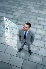 Image showing young smiling businessman outdoors from top