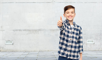 Image showing smiling boy in checkered shirt showing thumbs up