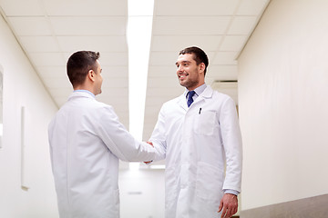 Image showing smiling doctors at hospital doing handshake