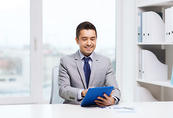 Image showing smiling businessman with tablet pc in office
