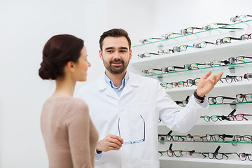 Image showing woman and optician showing glasses at optics store