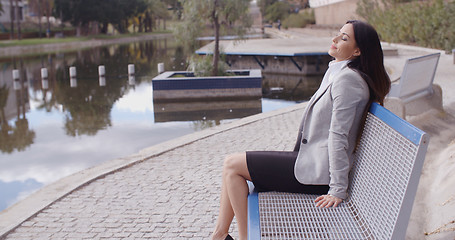 Image showing Business woman relaxing near canal