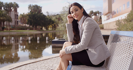 Image showing Gorgeous business woman sitting on bench