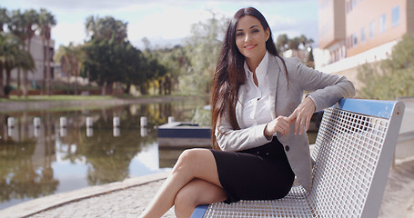 Image showing Gorgeous business woman sitting on bench