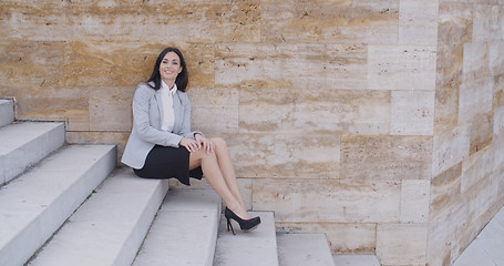 Image showing Serious woman sitting on stairs outdoors