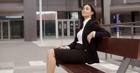 Image showing Calm business woman sitting outdoors