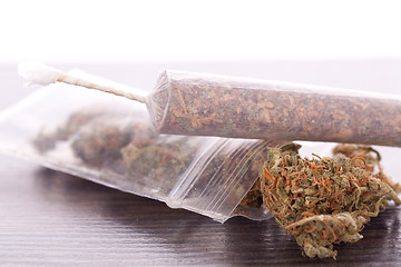 Image showing Close up of dried marijuana leaves and joint