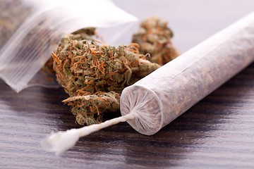 Image showing Close up of dried marijuana leaves and joint